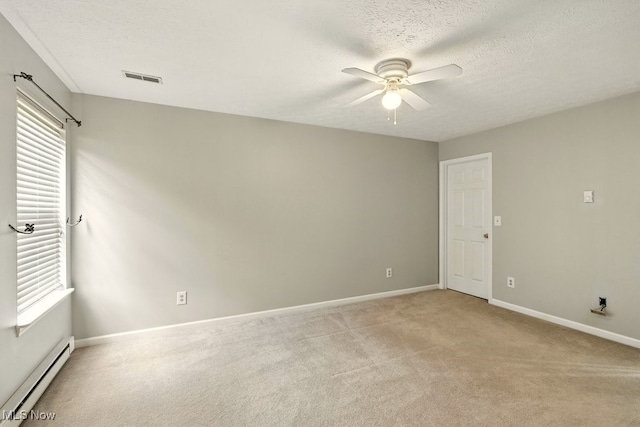 232 Damon Dr, Munroe Falls, OH 44262 - spare room with a baseboard heating unit, a ceiling fan, light carpet, plenty of natural light, and a textured ceiling