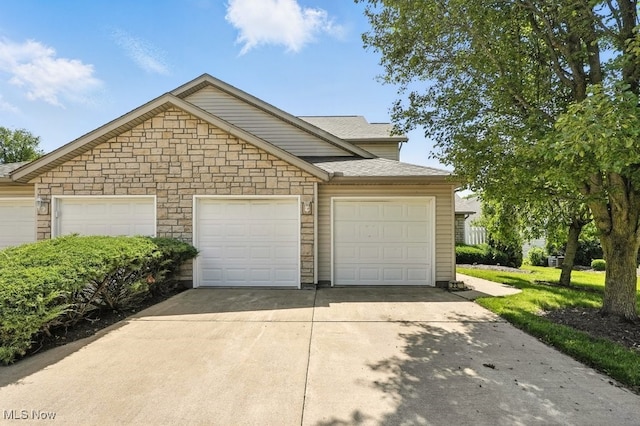 232 Damon Dr, Munroe Falls, OH 44262 - view of front of house with concrete driveway, stone siding, and a shingled roof