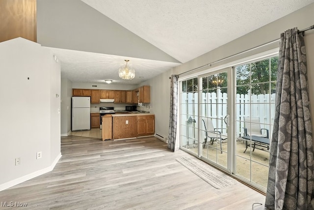 232 Damon Dr, Munroe Falls, OH 44262 - kitchen with white appliances, brown cabinetry, a chandelier, lofted ceiling, and a textured ceiling