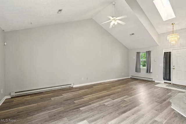232 Damon Dr, Munroe Falls, OH 44262 - unfurnished living room with baseboard heating, a chandelier, a skylight, high vaulted ceiling, and wood finished floors