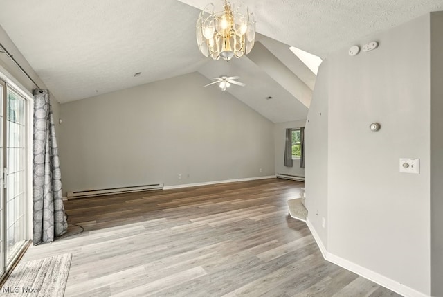 232 Damon Dr, Munroe Falls, OH 44262 - unfurnished living room featuring a baseboard radiator, a chandelier, vaulted ceiling, wood finished floors, and a ceiling fan