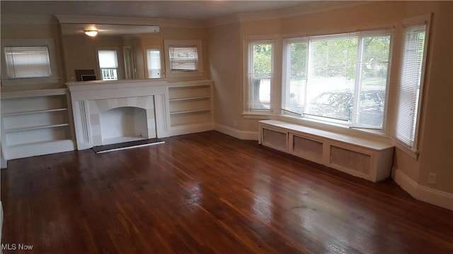 13558 Cedar Rd, University Heights, OH 44118 - unfurnished living room featuring dark wood finished floors, a tile fireplace, crown molding, and built in shelves