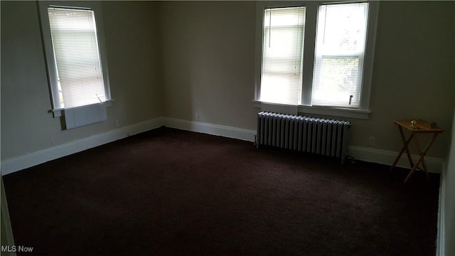 13558 Cedar Rd, University Heights, OH 44118 - spare room featuring radiator heating unit, dark colored carpet, and plenty of natural light