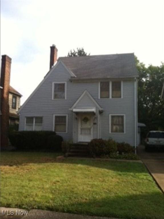 1157 Erieview Rd, Cleveland Heights, OH 44121 - view of front of house featuring a front lawn and a chimney