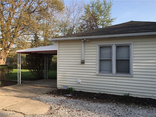 5785 Fitch Rd, North Olmsted, OH 44070 - view of side of property featuring a shingled roof and driveway