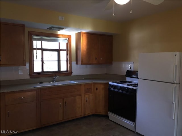 5785 Fitch Rd, North Olmsted, OH 44070 - kitchen with white appliances, brown cabinetry, decorative backsplash, a ceiling fan, and light countertops