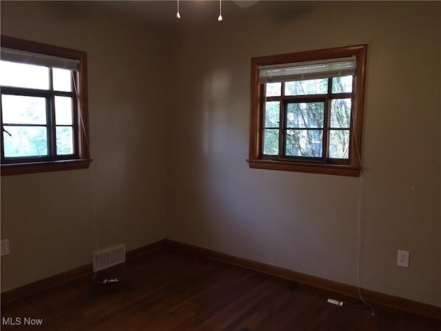 5785 Fitch Rd, North Olmsted, OH 44070 - empty room featuring dark wood-style flooring and baseboards
