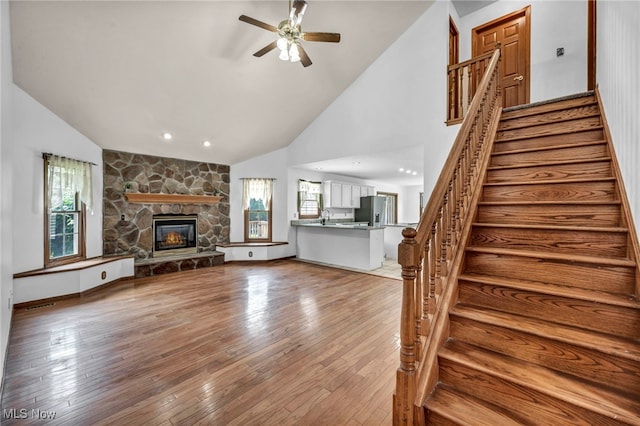 3578 County Line Rd, Madison, OH 44057 - unfurnished living room with healthy amount of natural light, ceiling fan, hardwood / wood-style flooring, high vaulted ceiling, and recessed lighting