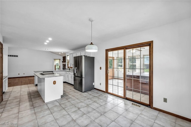 3578 County Line Rd, Madison, OH 44057 - kitchen with stainless steel refrigerator with ice dispenser, a peninsula, white cabinetry, vaulted ceiling, and decorative light fixtures