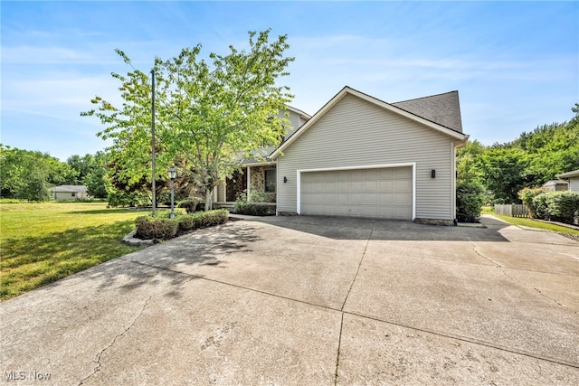 3578 County Line Rd, Madison, OH 44057 - view of front of house with driveway, an attached garage, and a front lawn