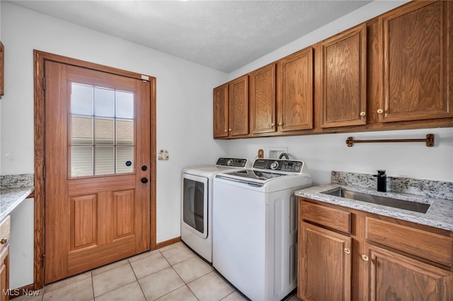 3578 County Line Rd, Madison, OH 44057 - washroom featuring washing machine and dryer, cabinet space, light tile patterned floors, and a textured ceiling