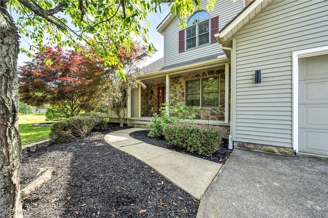 3578 County Line Rd, Madison, OH 44057 - view of exterior entry featuring stone siding and a garage