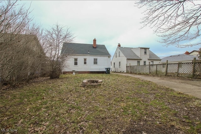 4607 Lincoln Ave, Parma, OH 44134 - back of house with a chimney and an outdoor fire pit