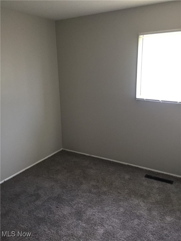 6078 Randolph Rd, Bedford Heights, OH 44146 - empty room with dark carpet and baseboards