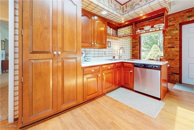 6803 County Road 22a, Bloomingdale, OH 43910 - kitchen featuring stainless steel dishwasher, light wood-style flooring, light countertops, and brown cabinets
