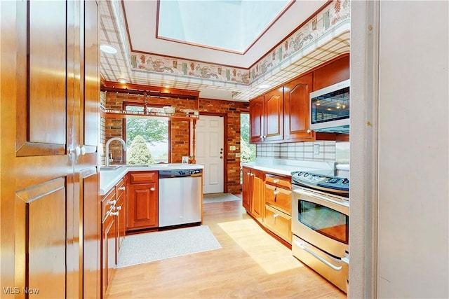 6803 County Road 22a, Bloomingdale, OH 43910 - kitchen featuring stainless steel appliances, light countertops, light wood finished floors, and a tray ceiling