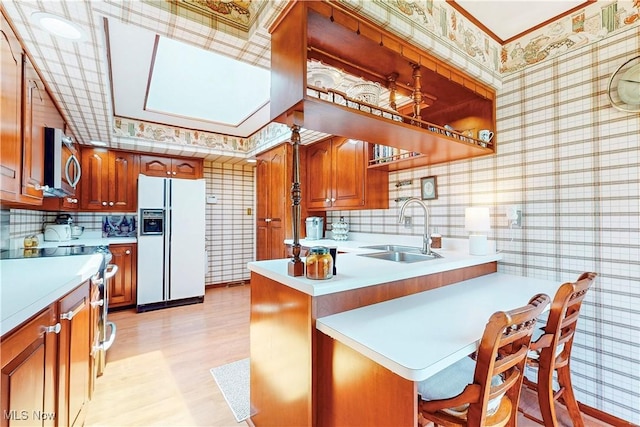 6803 County Road 22a, Bloomingdale, OH 43910 - kitchen with white fridge with ice dispenser, stainless steel microwave, wallpapered walls, a peninsula, and light countertops