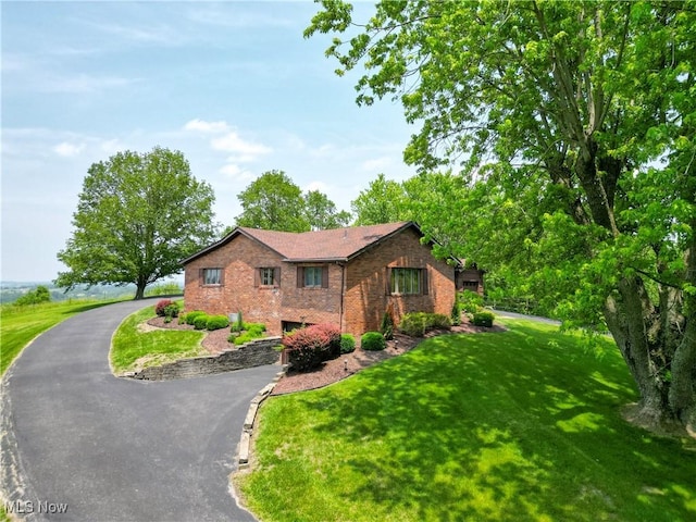 6803 County Road 22a, Bloomingdale, OH 43910 - view of front facade featuring brick siding, asphalt driveway, and a front lawn