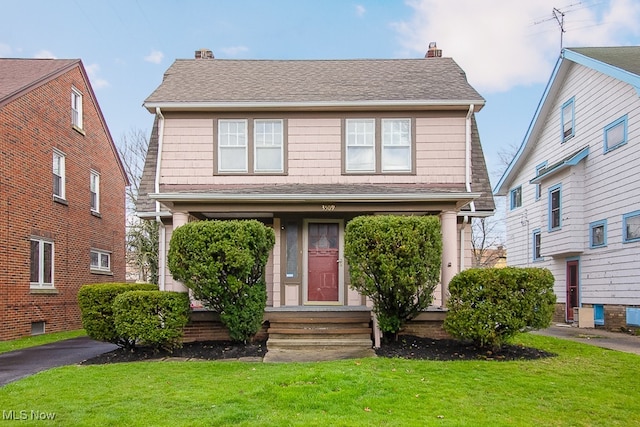 3509 Silsby Rd, University Heights, OH 44118 - view of front of home with a chimney, a front yard, and a shingled roof