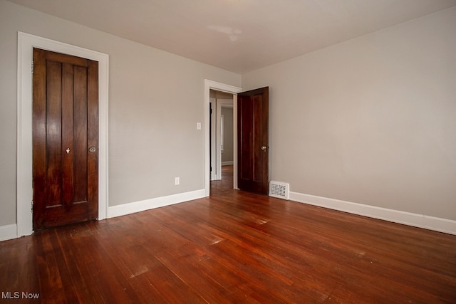 3509 Silsby Rd, University Heights, OH 44118 - unfurnished bedroom featuring dark wood-style floors and baseboards