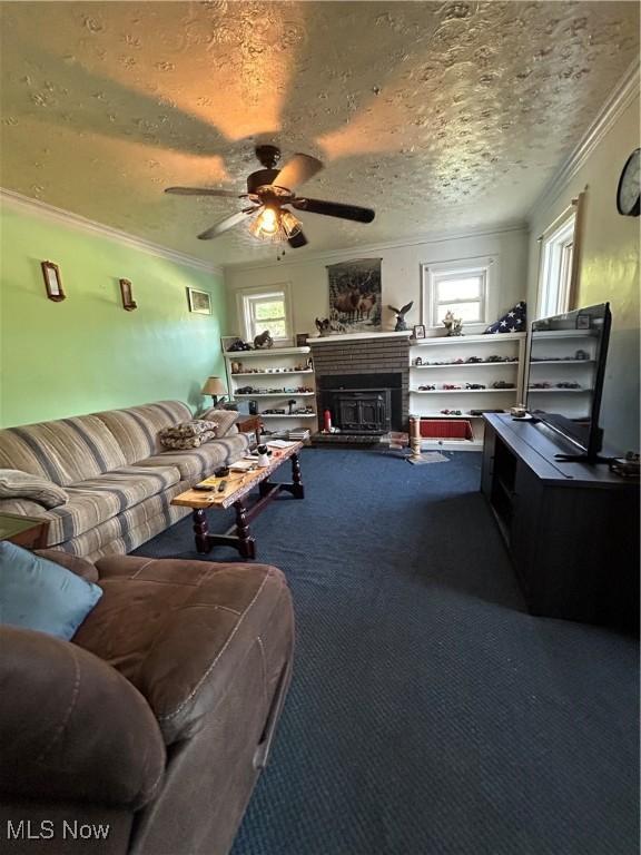 73 High St, Clay, WV 25043 - carpeted living room with healthy amount of natural light, ornamental molding, ceiling fan, a textured ceiling, and a fireplace