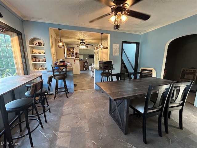 73 High St, Clay, WV 25043 - dining room with a ceiling fan, arched walkways, crown molding, stairway, and built in shelves