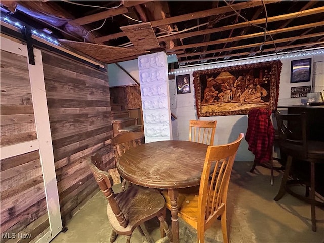 73 High St, Clay, WV 25043 - dining area with unfinished concrete floors and wooden walls
