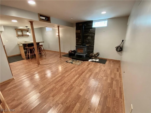 13781 Rustic Dr, North Royalton, OH 44133 - below grade area featuring wood finished floors, a wood stove, recessed lighting, and bar