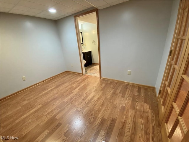 13781 Rustic Dr, North Royalton, OH 44133 - empty room with a drop ceiling and light wood-style flooring