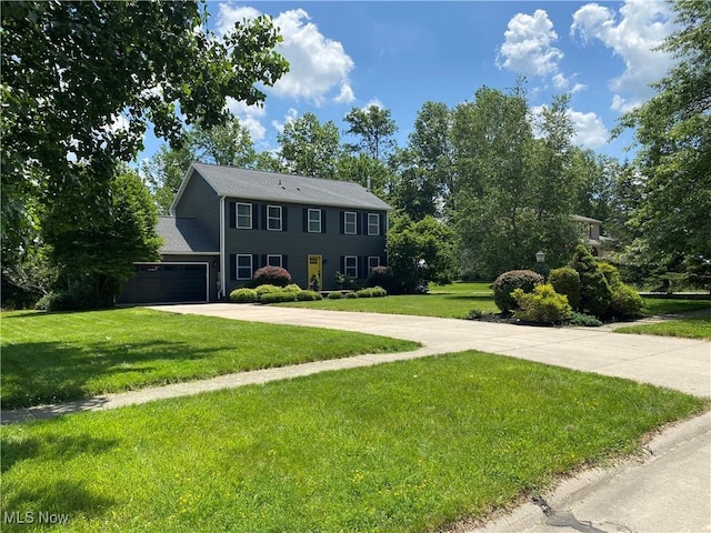 13781 Rustic Dr, North Royalton, OH 44133 - colonial house featuring driveway, a front lawn, and an attached garage