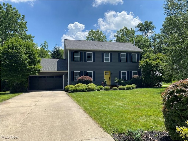 13781 Rustic Dr, North Royalton, OH 44133 - colonial house featuring an attached garage, concrete driveway, and a front lawn