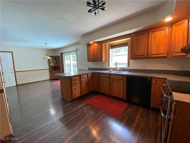 13781 Rustic Dr, North Royalton, OH 44133 - kitchen with black dishwasher, a peninsula, dark wood finished floors, a textured ceiling, and brown cabinetry