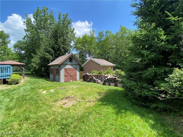 13781 Rustic Dr, North Royalton, OH 44133 - view of grassy yard featuring a storage shed and a detached garage
