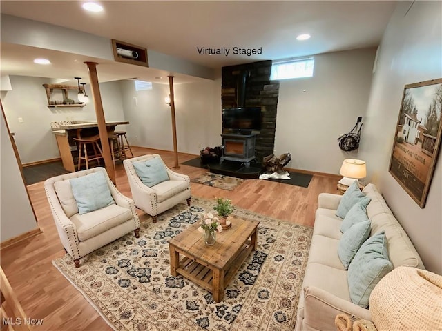 13781 Rustic Dr, North Royalton, OH 44133 - living area featuring a wood stove, wood finished floors, bar, and recessed lighting