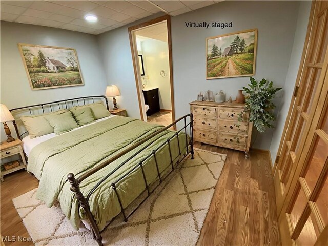 13781 Rustic Dr, North Royalton, OH 44133 - bedroom featuring a drop ceiling, wood finished floors, and ensuite bathroom