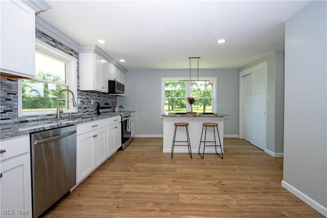 290 State Route 60, Greenwich, OH 44837 - kitchen with appliances with stainless steel finishes, backsplash, white cabinets, light stone counters, and recessed lighting