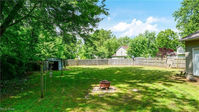 9009 Oak Ct, Windham, OH 44288 - fenced backyard featuring an outdoor fire pit