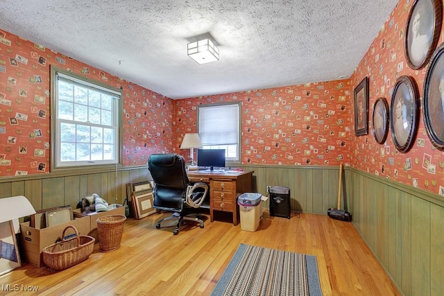 9502 Winchester Vly, Chesterland, OH 44026 - office with wood finished floors, plenty of natural light, a wainscoted wall, a textured ceiling, and wallpapered walls
