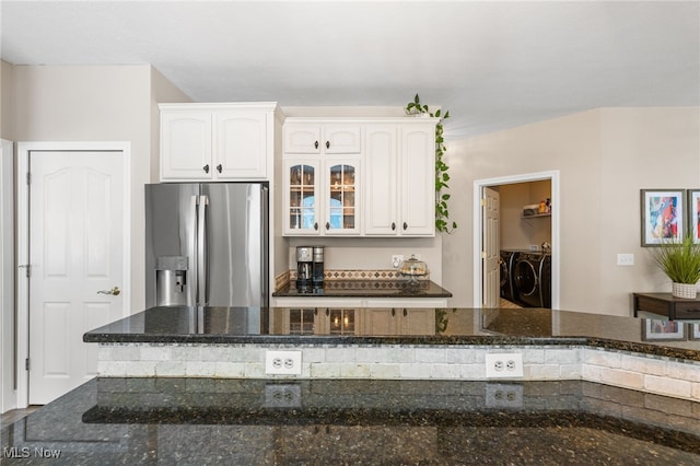 3519 Hawthorne Trl, Broadview Heights, OH 44147 - kitchen featuring stainless steel fridge with ice dispenser, washing machine and clothes dryer, white cabinets, dark stone counters, and glass insert cabinets