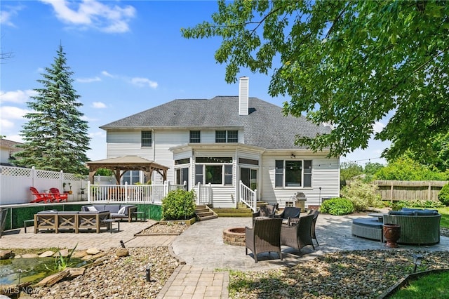 3519 Hawthorne Trl, Broadview Heights, OH 44147 - back of property featuring a gazebo, an outdoor living space with a fire pit, a patio, a chimney, and a shingled roof