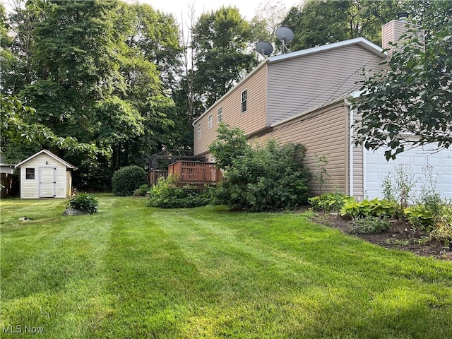 8602 Wedgewood Ave NW, North Canton, OH 44720 - view of green lawn with a storage unit and a deck