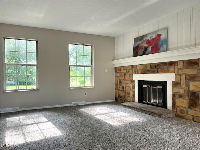 8602 Wedgewood Ave NW, North Canton, OH 44720 - unfurnished living room featuring carpet flooring, healthy amount of natural light, and a fireplace