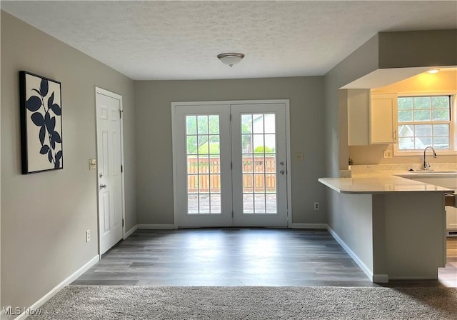 8602 Wedgewood Ave NW, North Canton, OH 44720 - doorway to outside with healthy amount of natural light, wood finished floors, and a textured ceiling