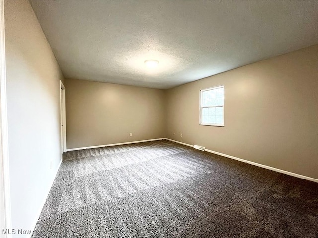 8602 Wedgewood Ave NW, North Canton, OH 44720 - unfurnished room with carpet and a textured ceiling