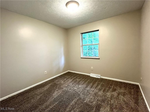 8602 Wedgewood Ave NW, North Canton, OH 44720 - unfurnished room with dark carpet and a textured ceiling