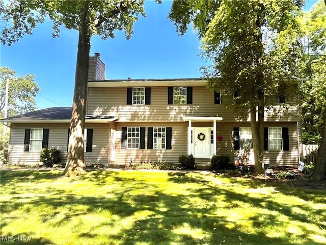 8602 Wedgewood Ave NW, North Canton, OH 44720 - view of front of house featuring a front yard and a chimney