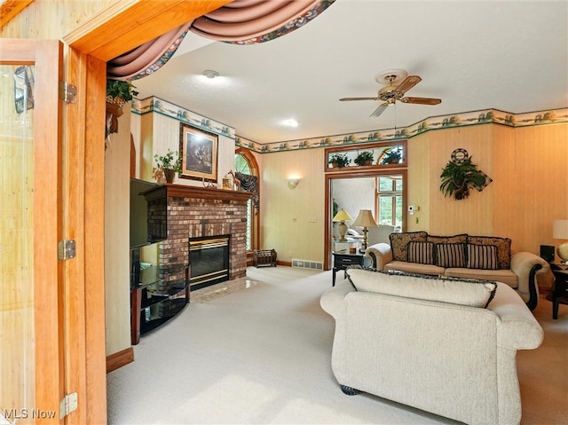2526 Ashbrook Dr, Ashtabula, OH 44004 - carpeted living area with a ceiling fan, a brick fireplace, and wooden walls