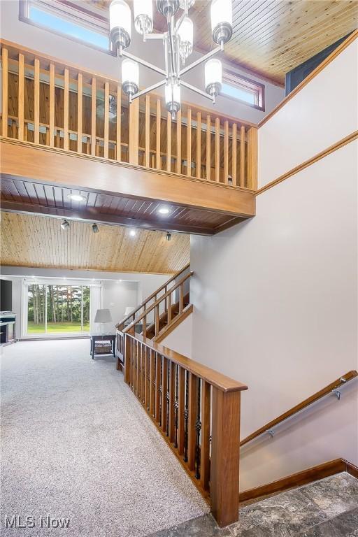 13645 Salem Church St NE, Paris, OH 44669 - staircase featuring wooden ceiling, a chandelier, carpet flooring, and a high ceiling