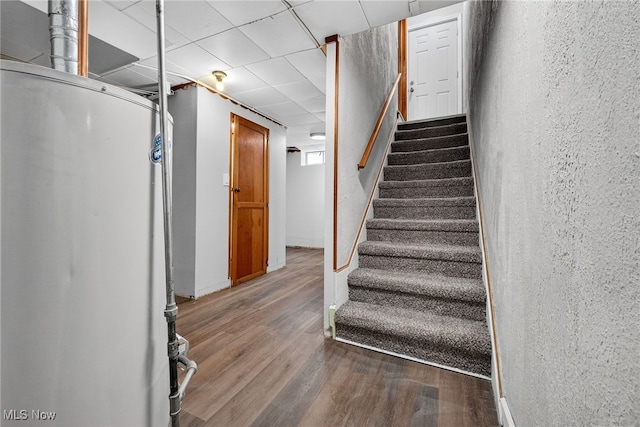 5077 Catherine St, Maple Heights, OH 44137 - staircase with wood finished floors, a textured wall, and a drop ceiling
