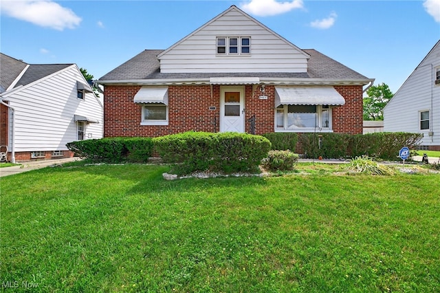 5077 Catherine St, Maple Heights, OH 44137 - bungalow-style home featuring brick siding, a front lawn, and a shingled roof